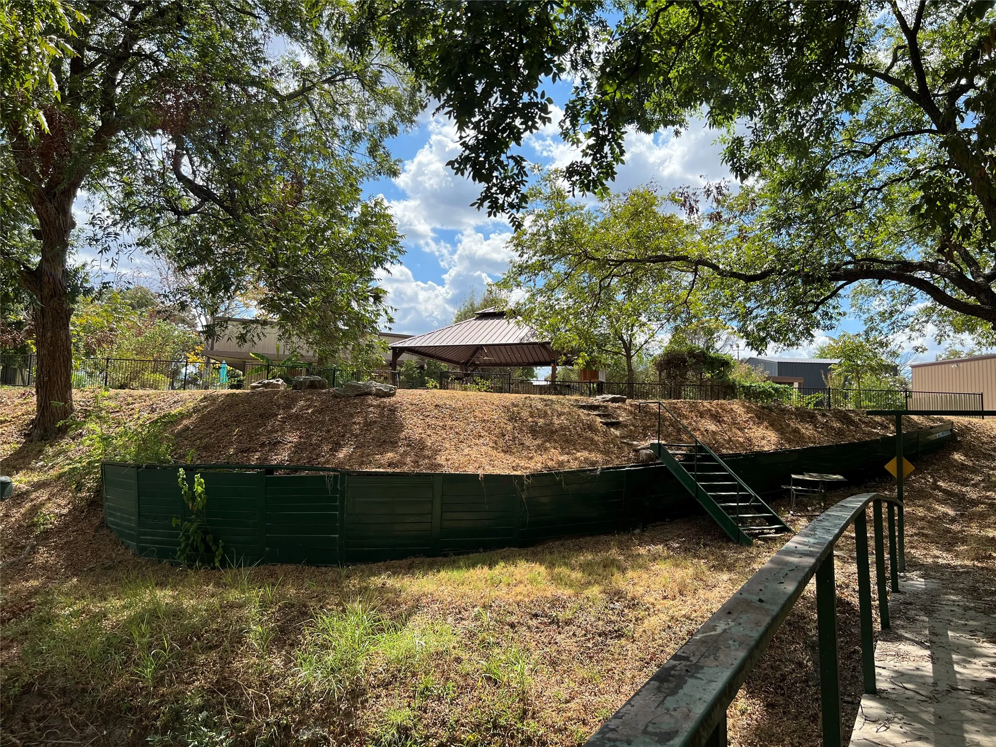 gazebo with a metal roof from substancial bridge to chicken coop area.