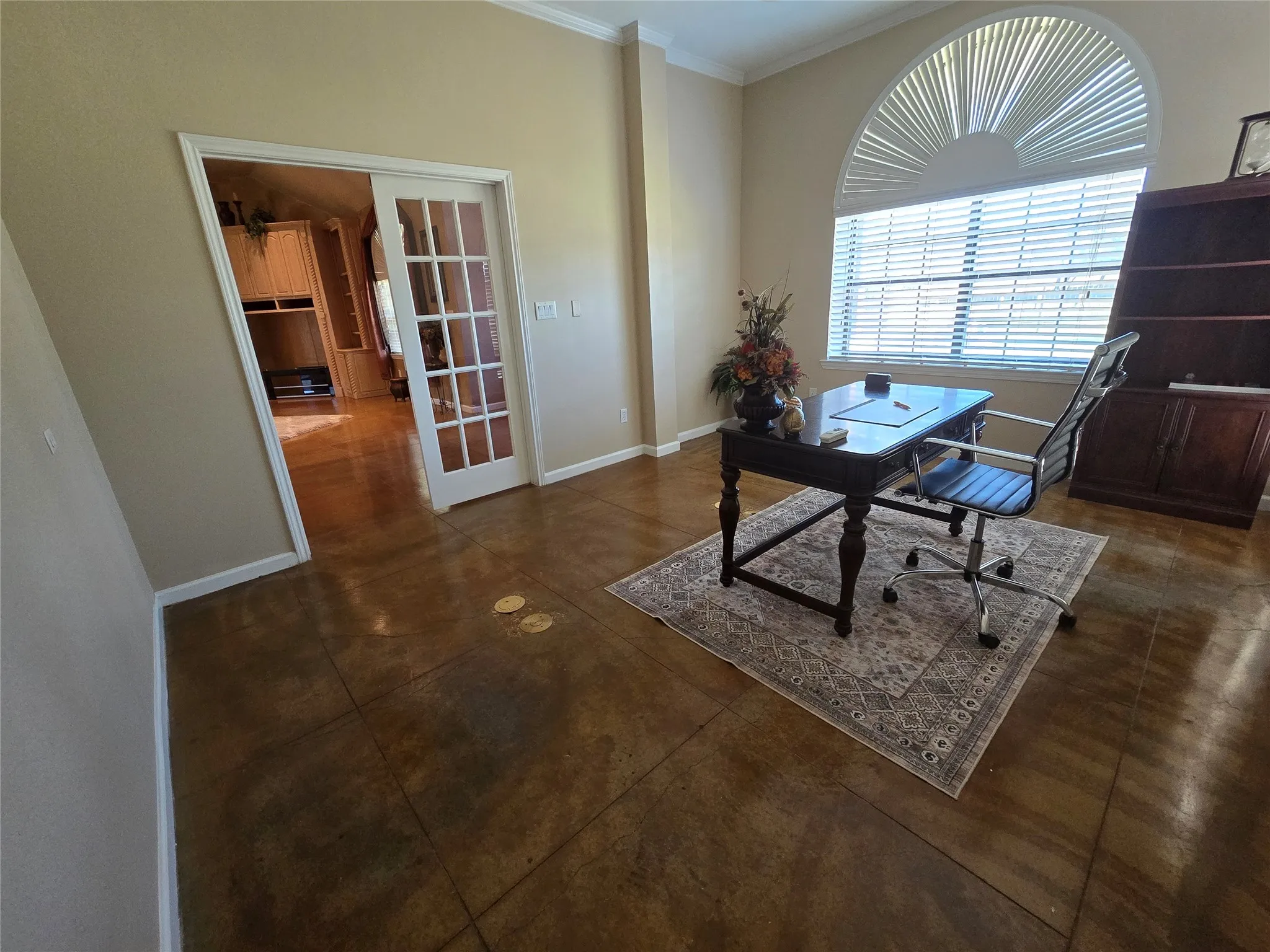 Office area with crown molding and french doors