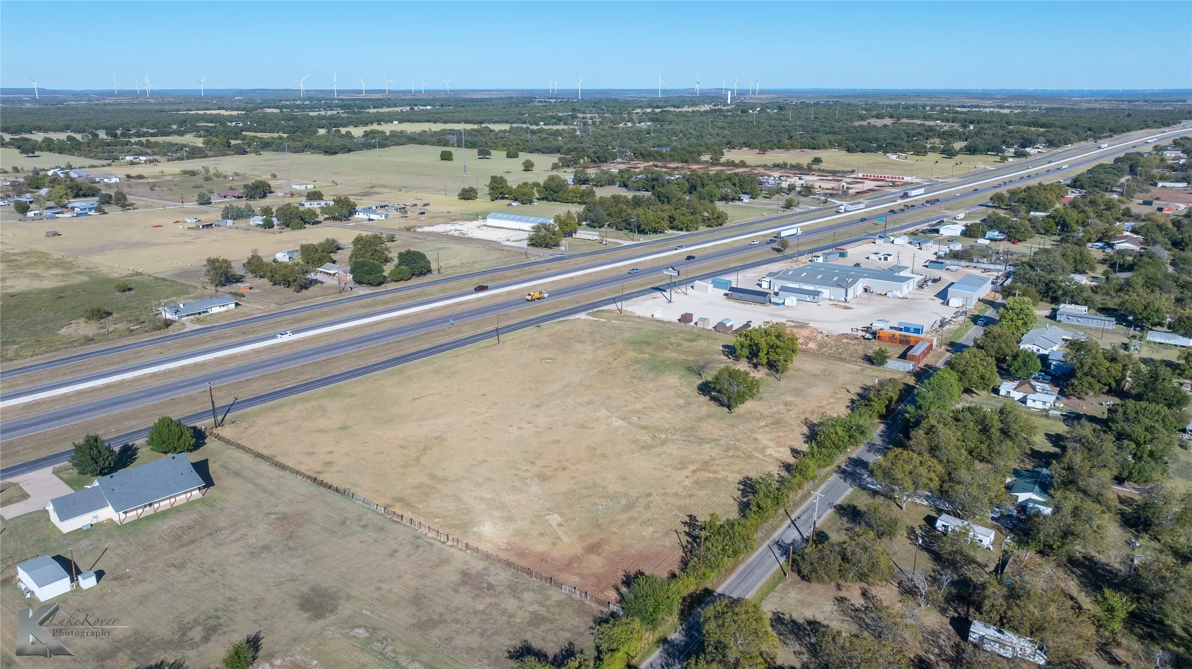 Aerial view of property's location featuring a tree filled landscape