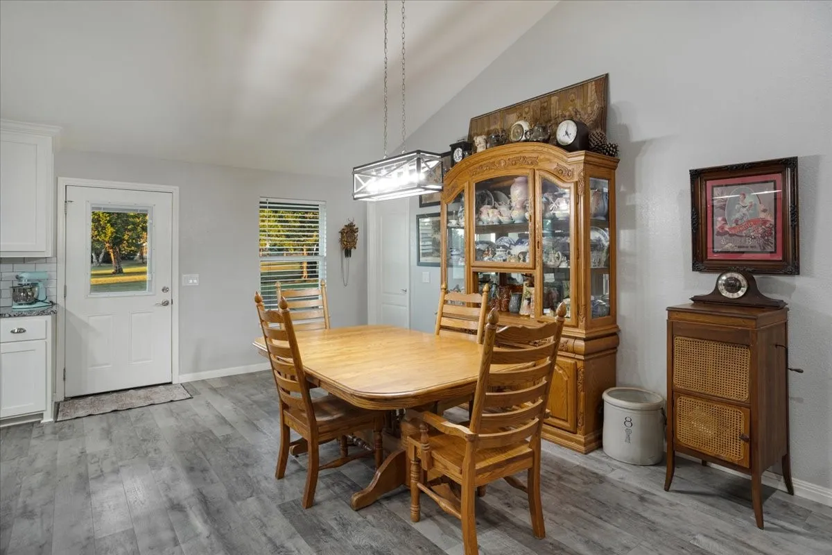 Dining space featuring light wood finished floors and lofted ceiling