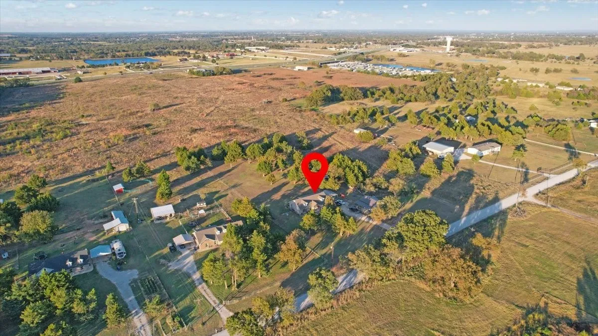 Aerial view of property and surrounding area featuring rural landscape
