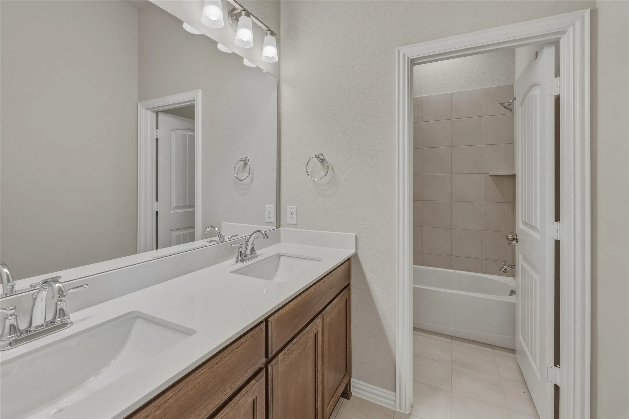 Dual vanity with white countertops, undermount sinks, and chrome fixtures
