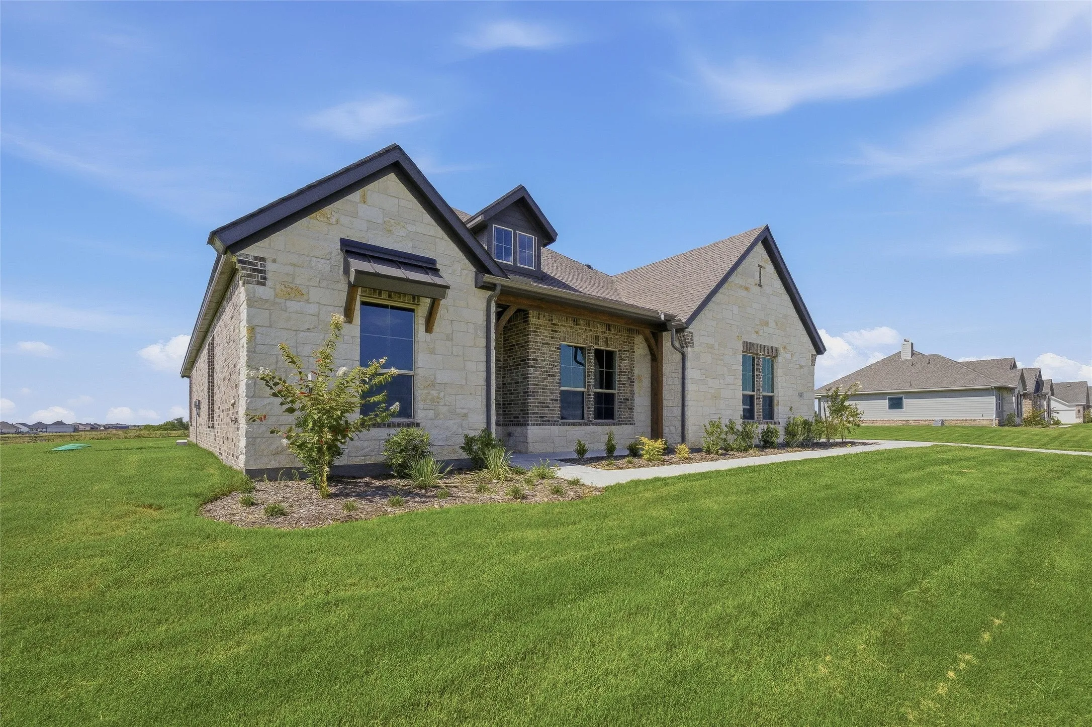 Stone and brick exterior with dark trim and a gabled roof