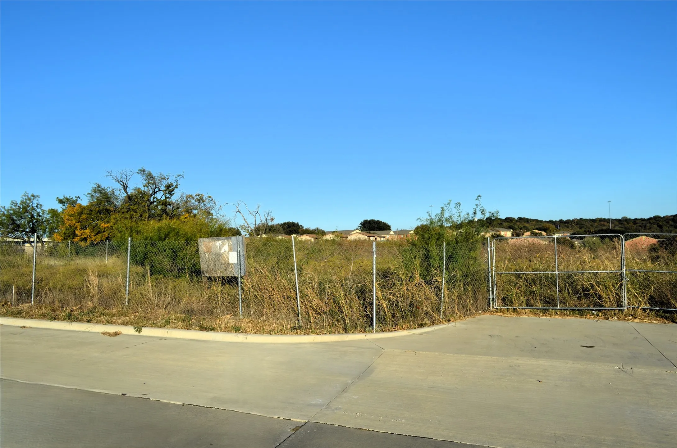 View of concrete road featuring curbs