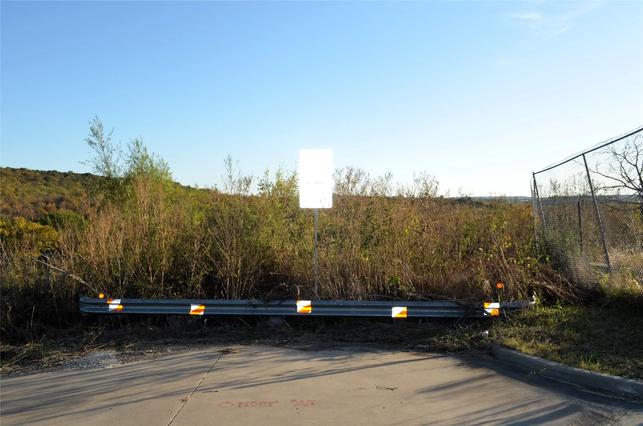 View of concrete road with curbs