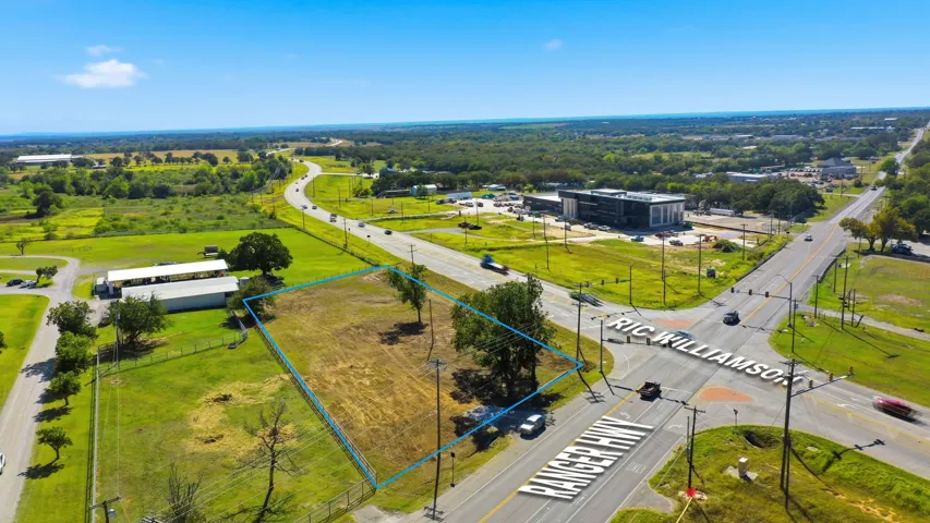 Aerial view of property and surrounding area featuring property parcel outlined