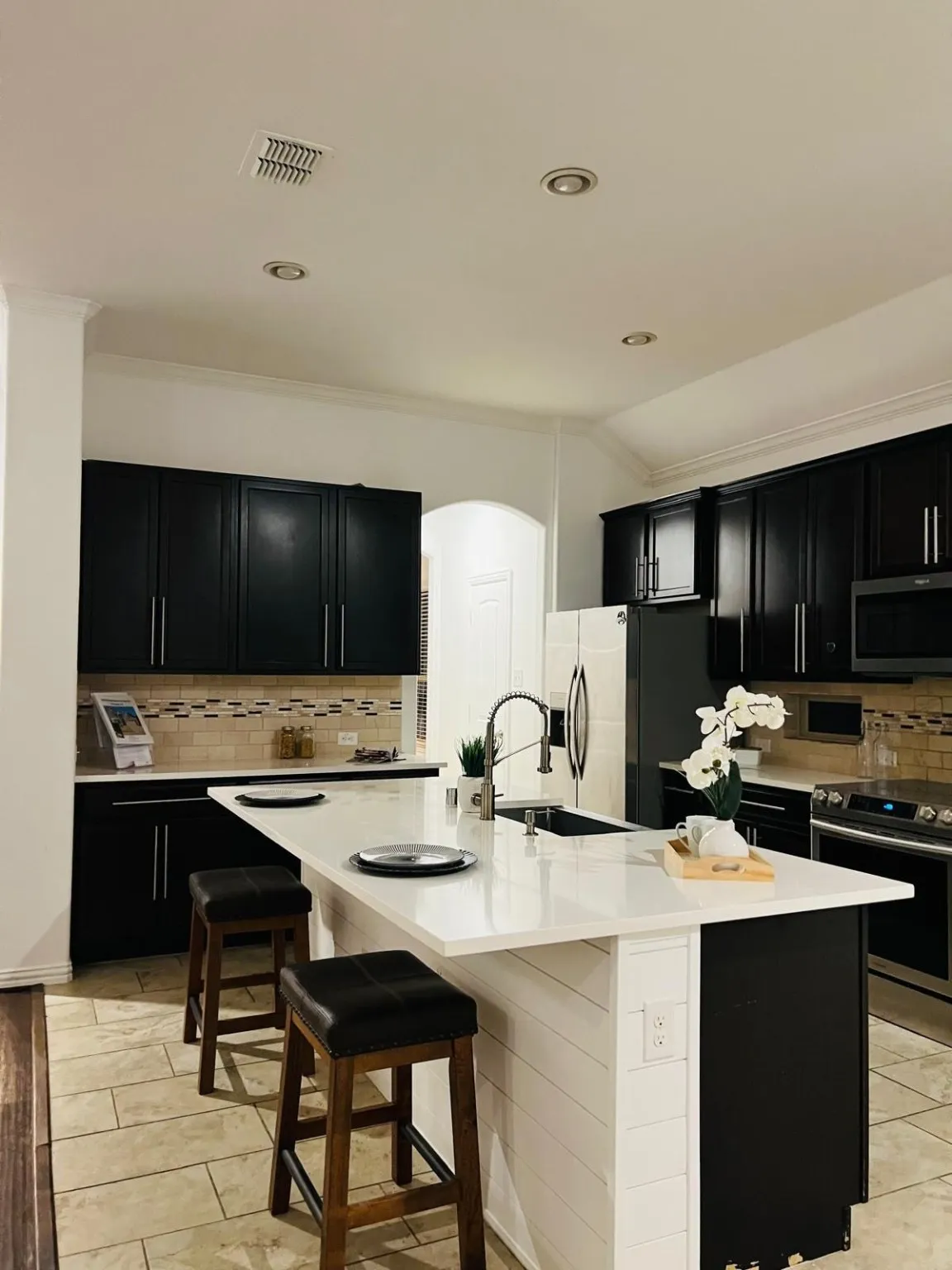 Lots of cabinets and large island attached is formal dining
