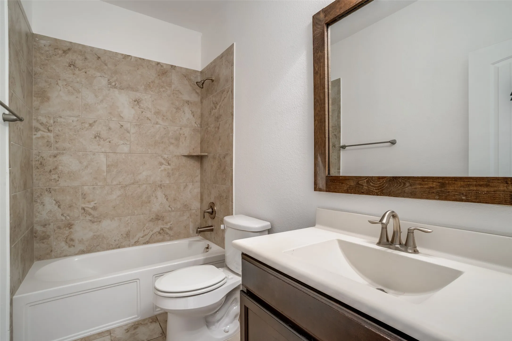 secondary bathroom with updated tile and countertops