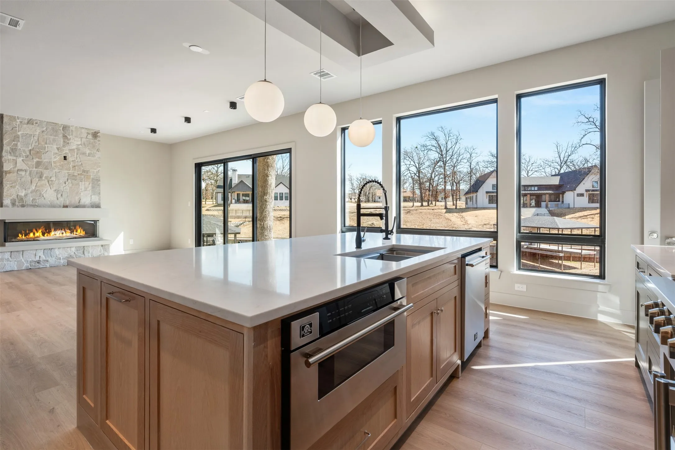 Electric fireplace with sliding floor to ceiling glass doors with views of lake