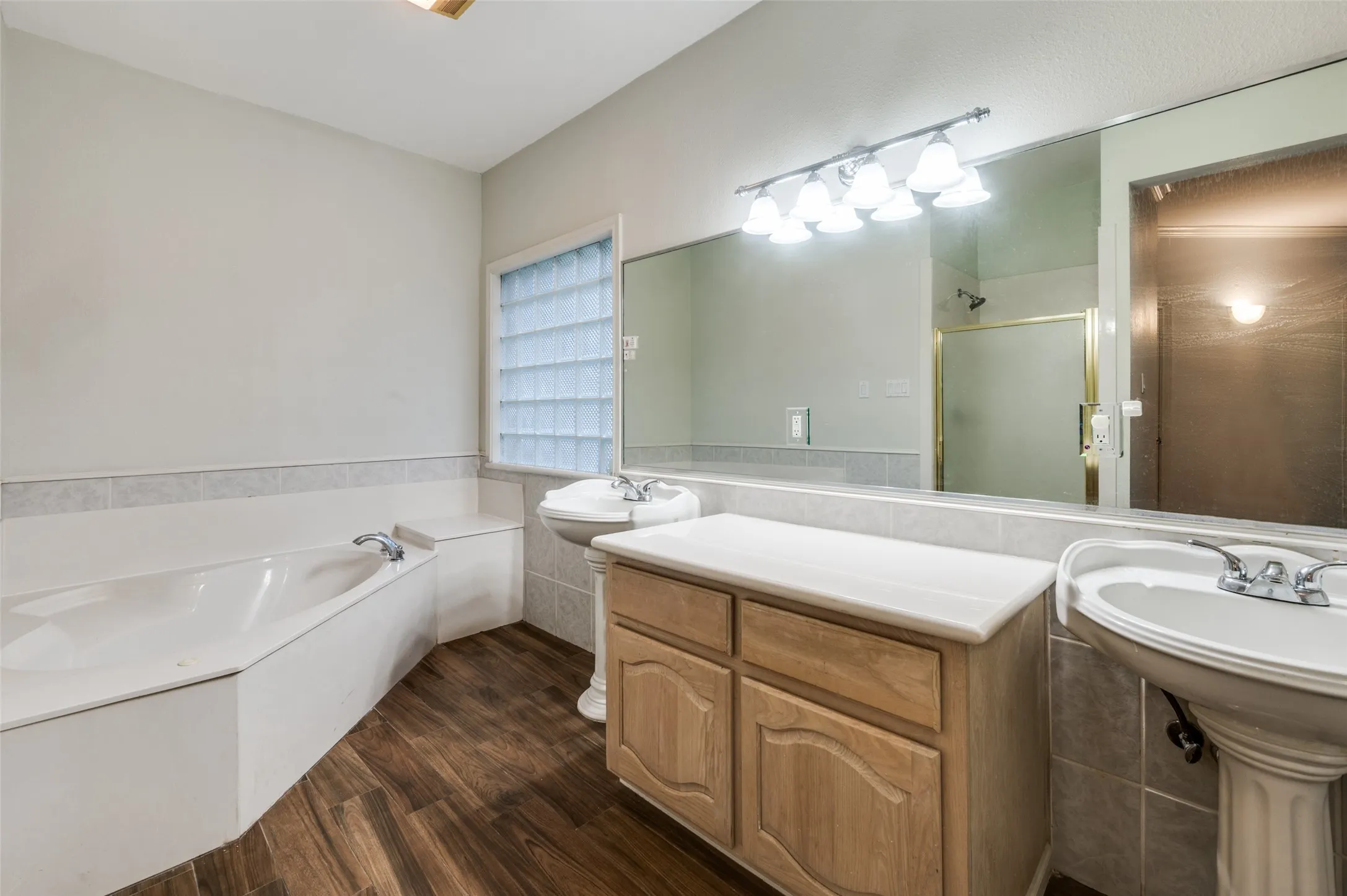 Separate jetted tub in this HUGE primary bathroom!