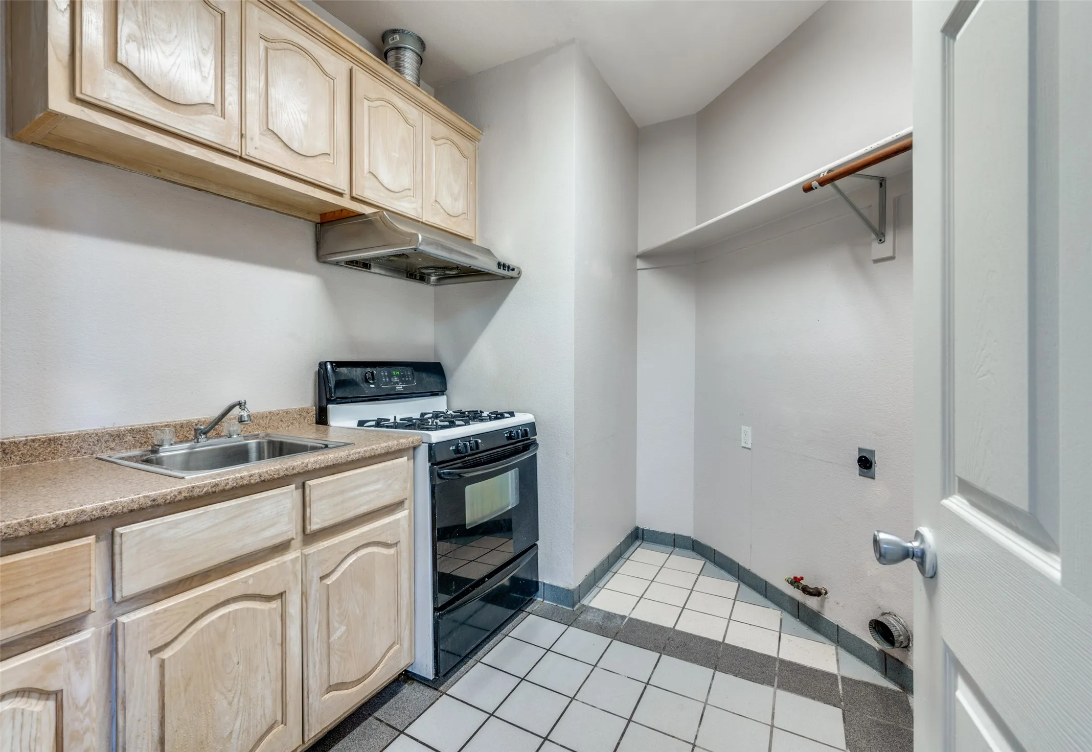 Laundry & Mini Kitchen with full secondary range and oven sink AND laundry sink, all adjacent to main kitchen