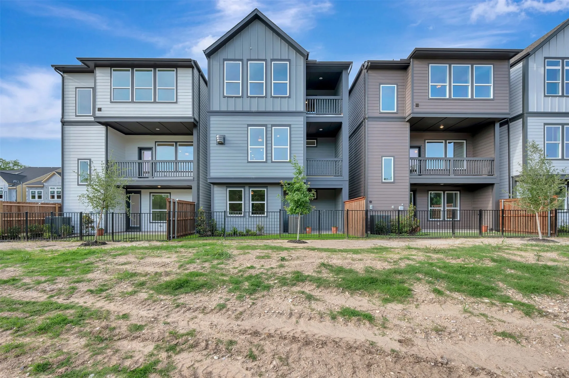 Modern townhome architecture featuring multi-story designs with private balconies and patios