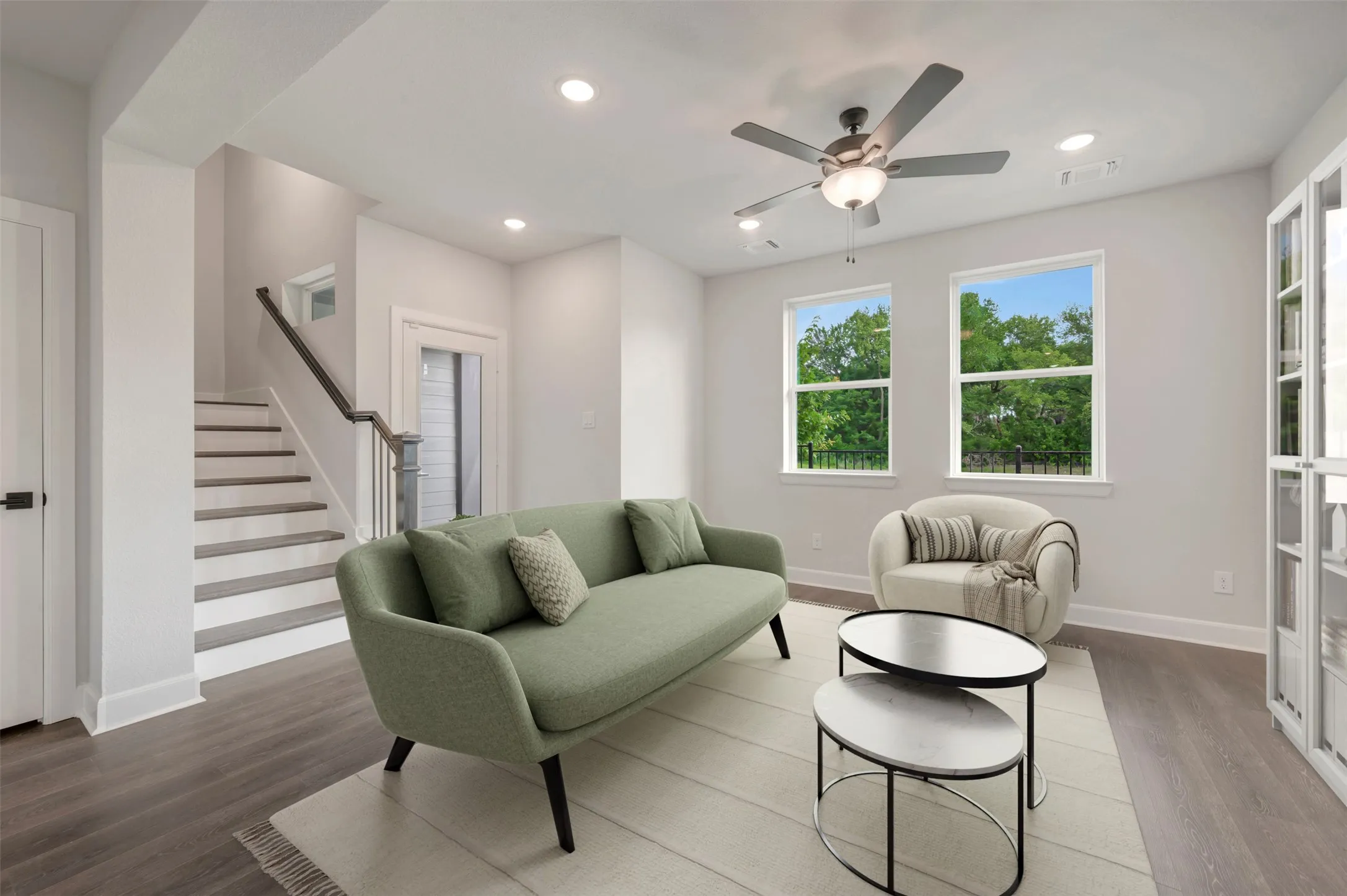 Living area featuring wood-finish flooring, recessed lighting, and a ceiling fan