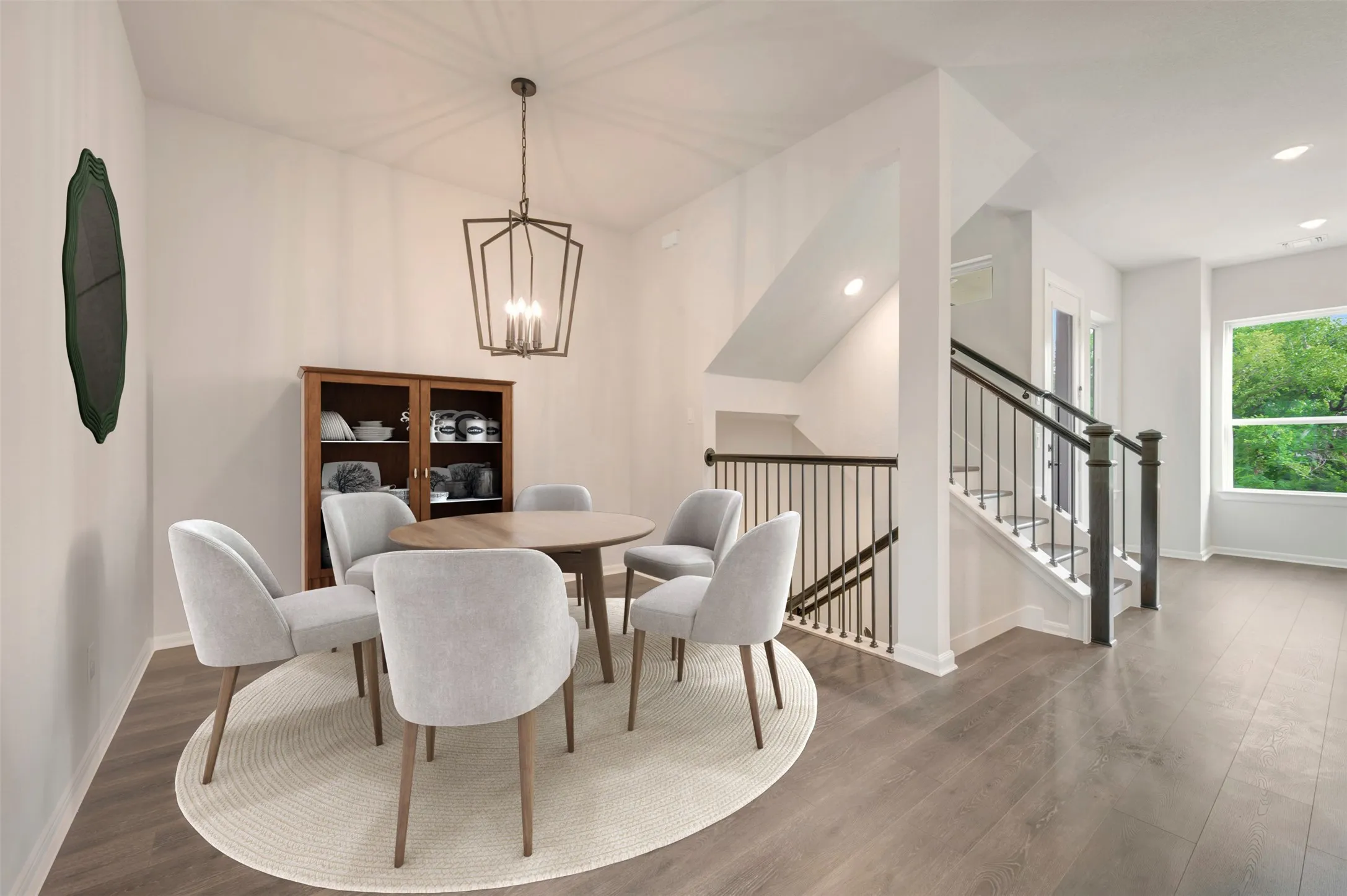 Dining area featuring a contemporary chandelier, wood-finish flooring, and white baseboards