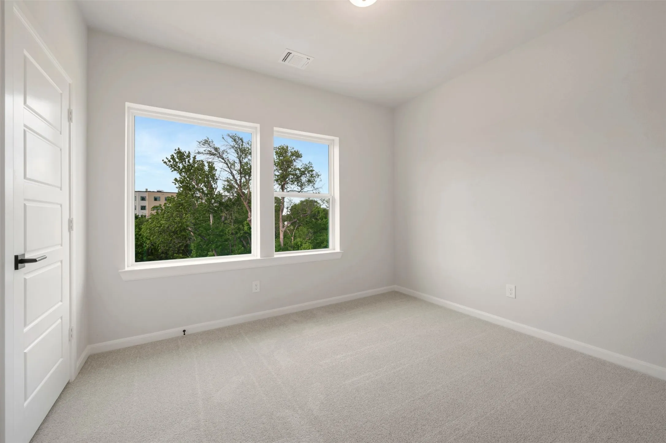 Bedroom featuring light gray carpet flooring and white painted walls
