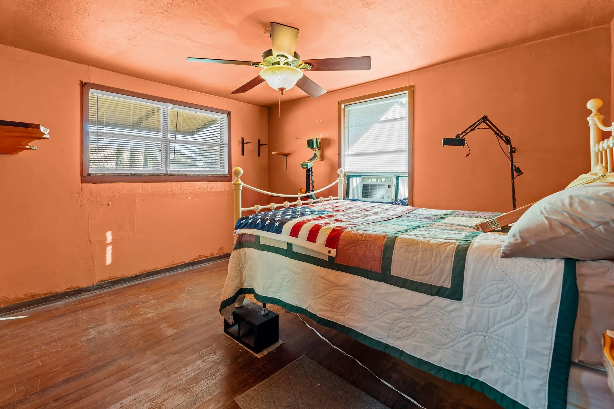 Bedroom with wood finished floors, a ceiling fan, and a textured ceiling