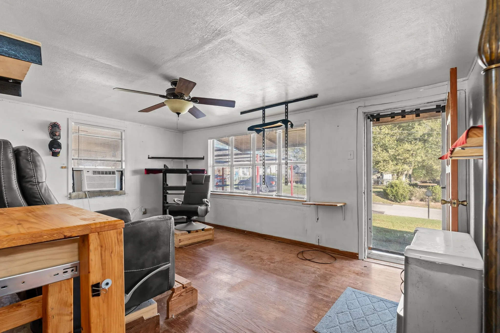 Office space featuring a textured ceiling, wood finished floors, and ceiling fan