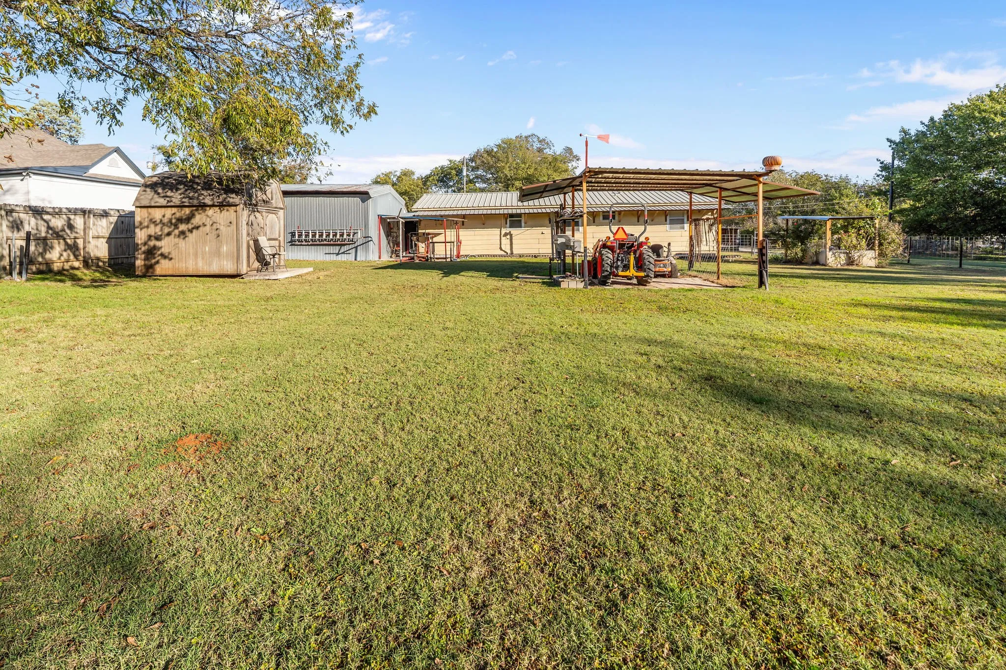 Rear view of property with a storage shed, a patio area, and a metal roof