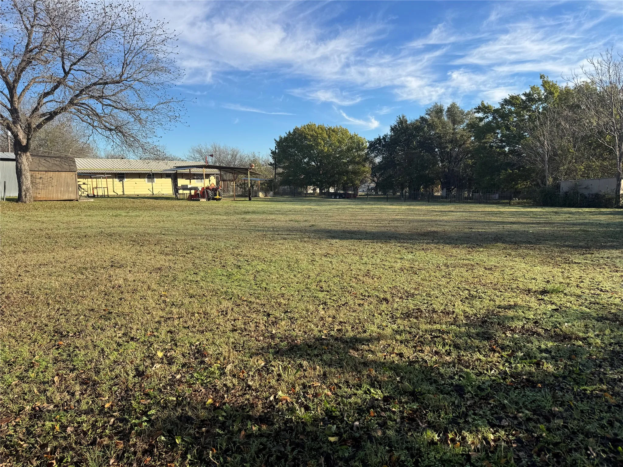 View of green lawn with an outbuilding