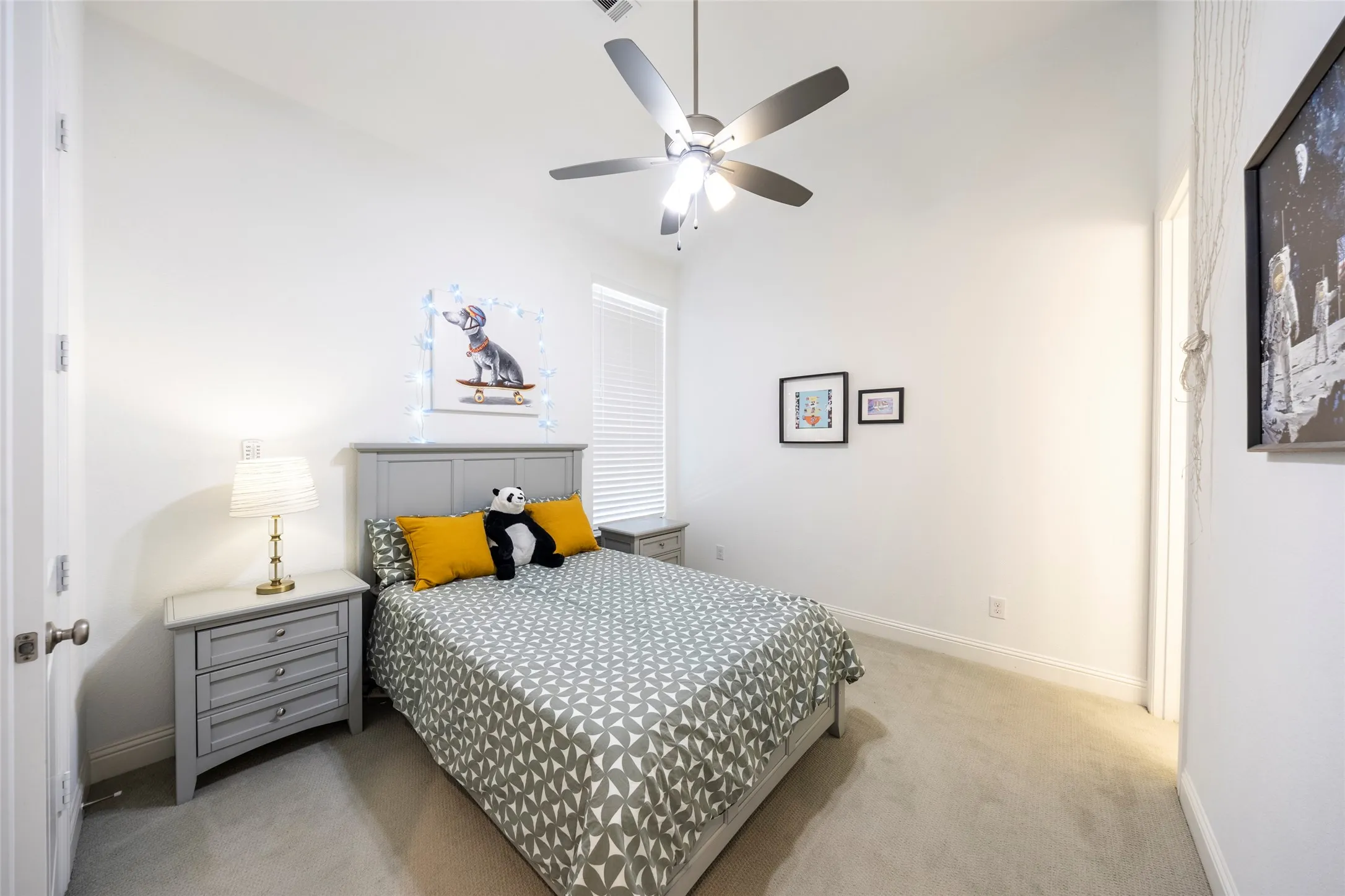 Bedroom featuring light carpet and a ceiling fan