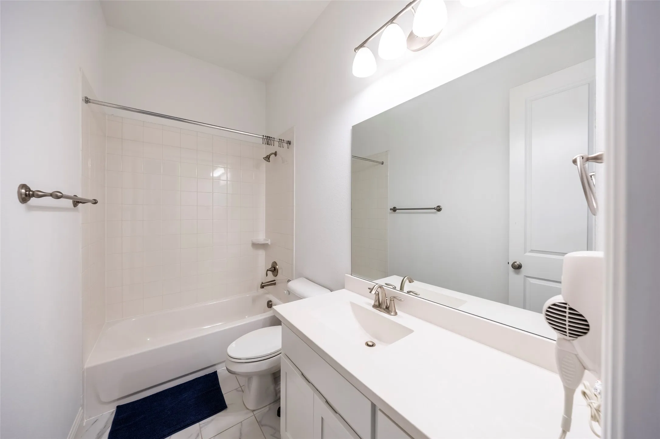 Full bath featuring shower / washtub combination and vanity