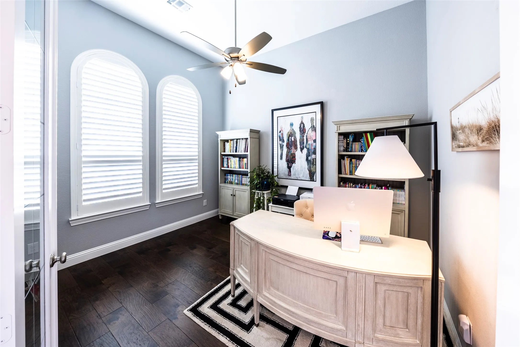 Office space featuring dark wood-style flooring and ceiling fan
