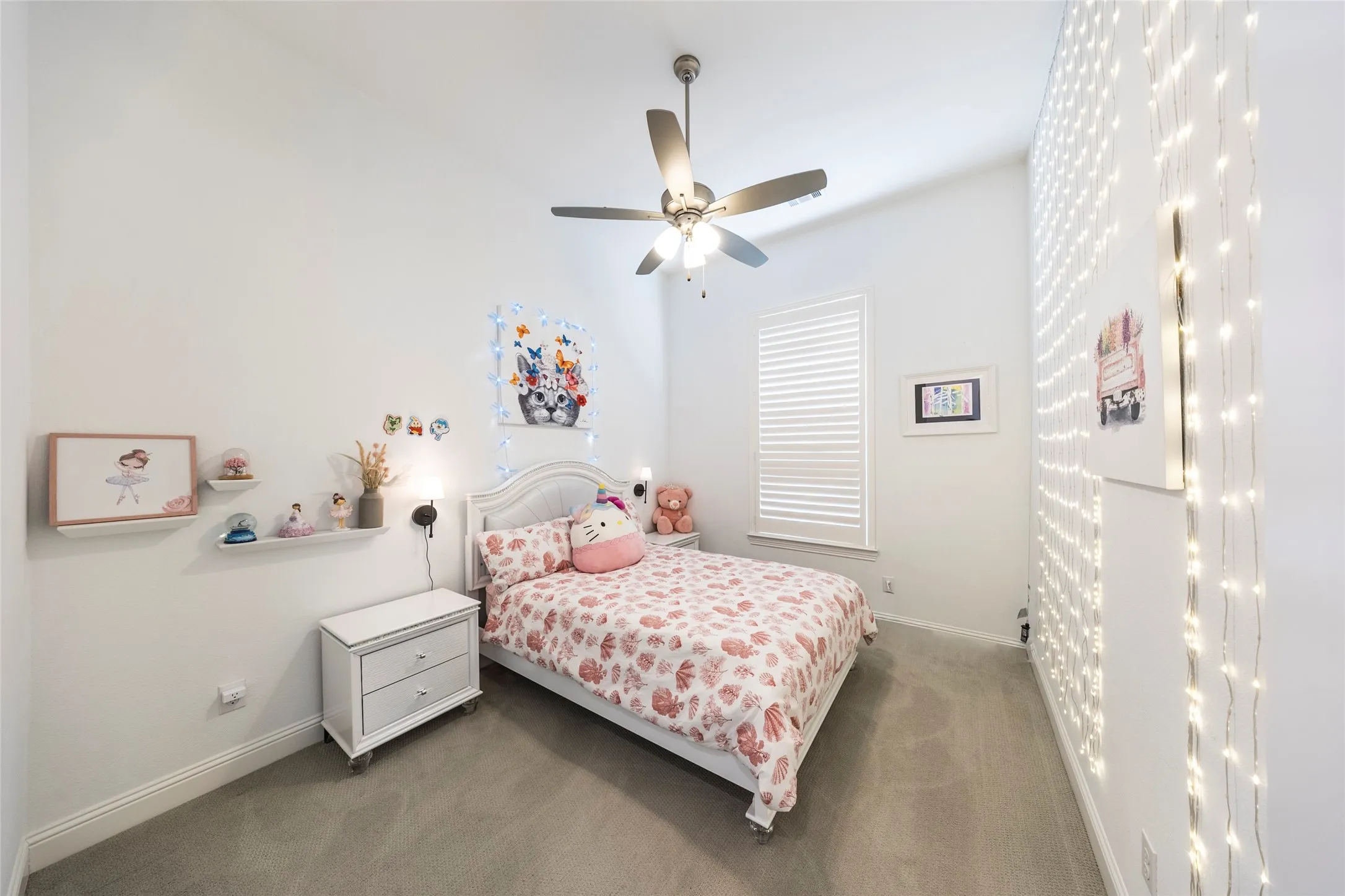 Carpeted bedroom featuring ceiling fan and baseboards
