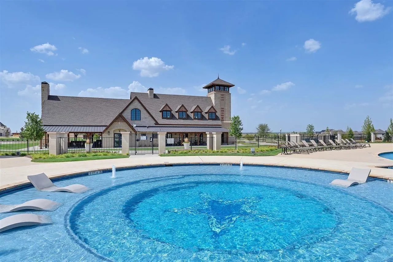 Community pool with a patio