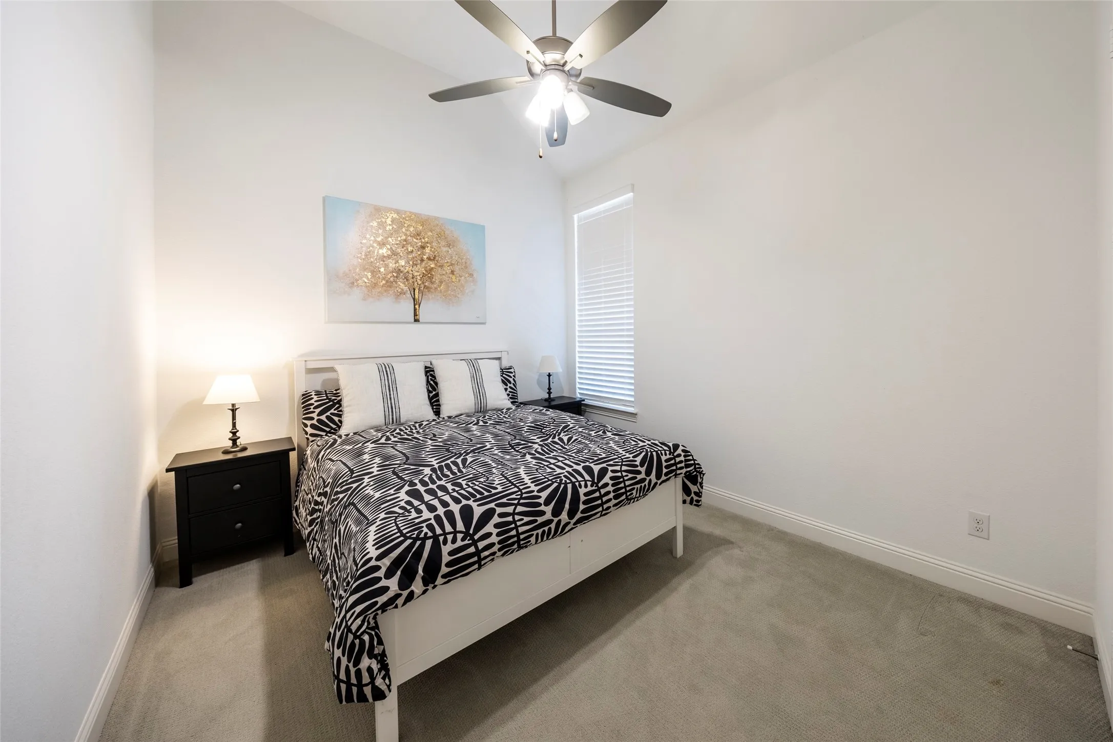 Bedroom with carpet floors, lofted ceiling, and ceiling fan