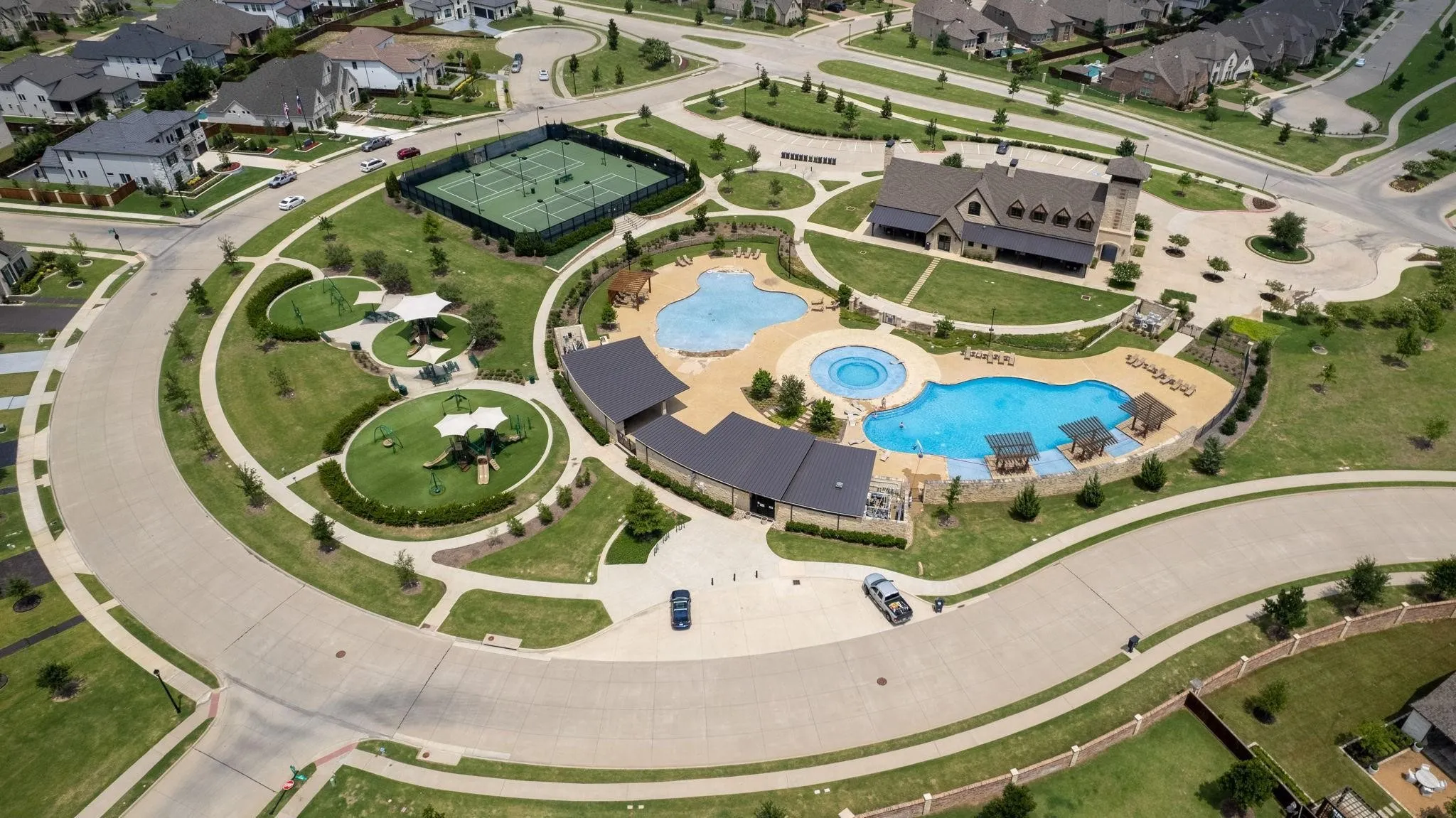 Aerial overview of property's location with a pool and nearby suburban area