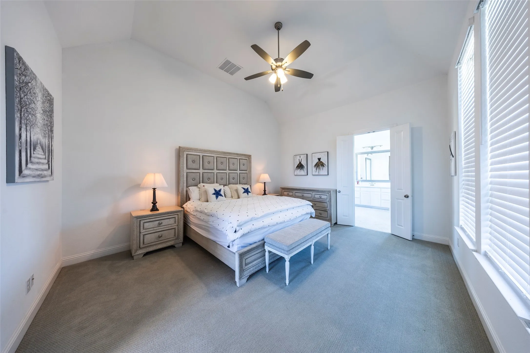 Bedroom with carpet flooring, lofted ceiling, a ceiling fan, and ensuite bathroom