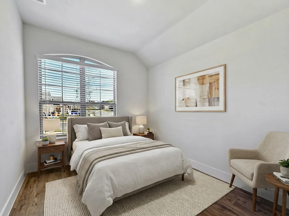 Room featuring an arched window & wood-finish flooring that could be used as a bedroom or an office as shown in the photo
