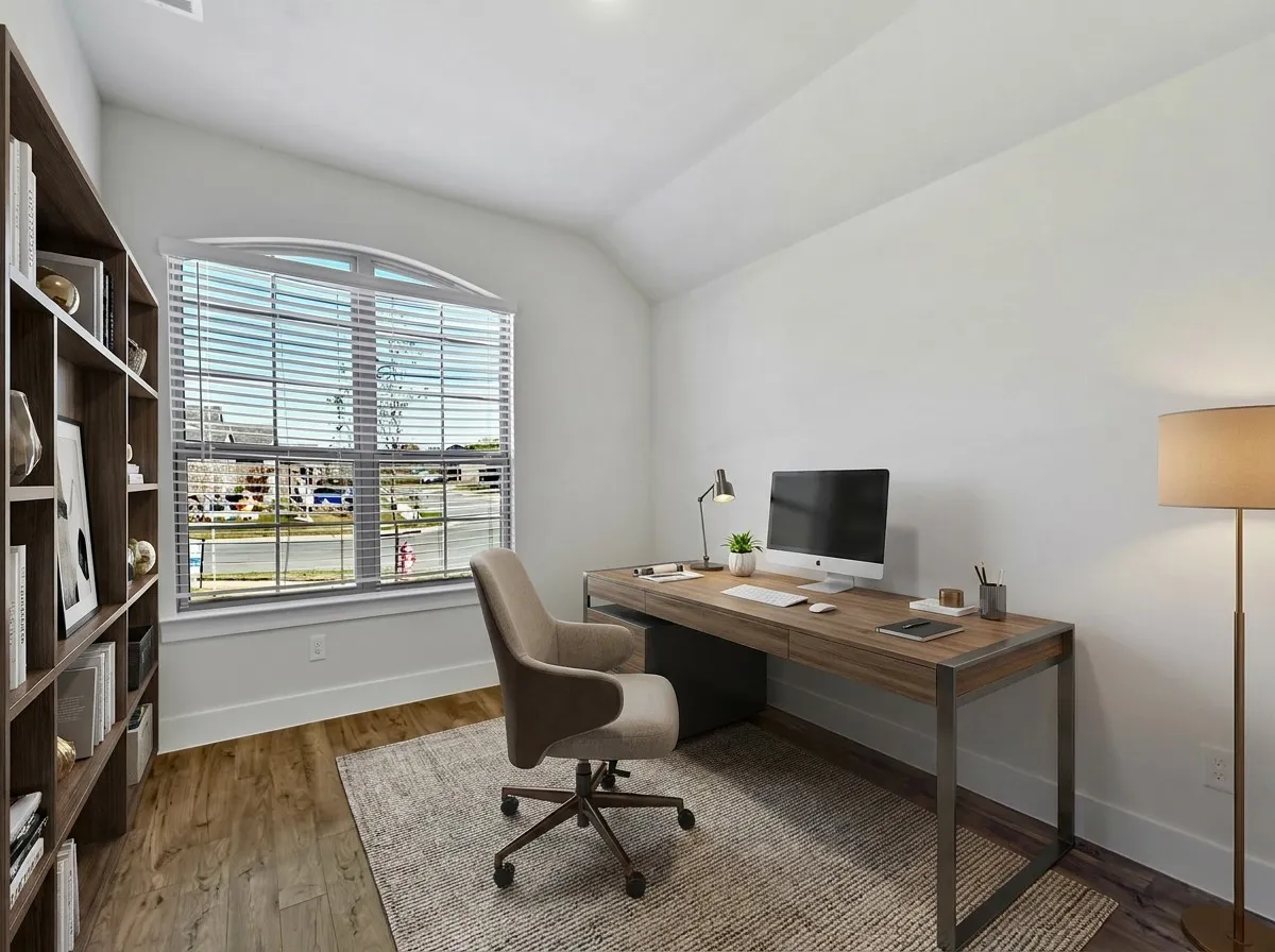 Room featuring an arched window & wood-finish flooring that could be used as a bedroom or an office as shown in the photo