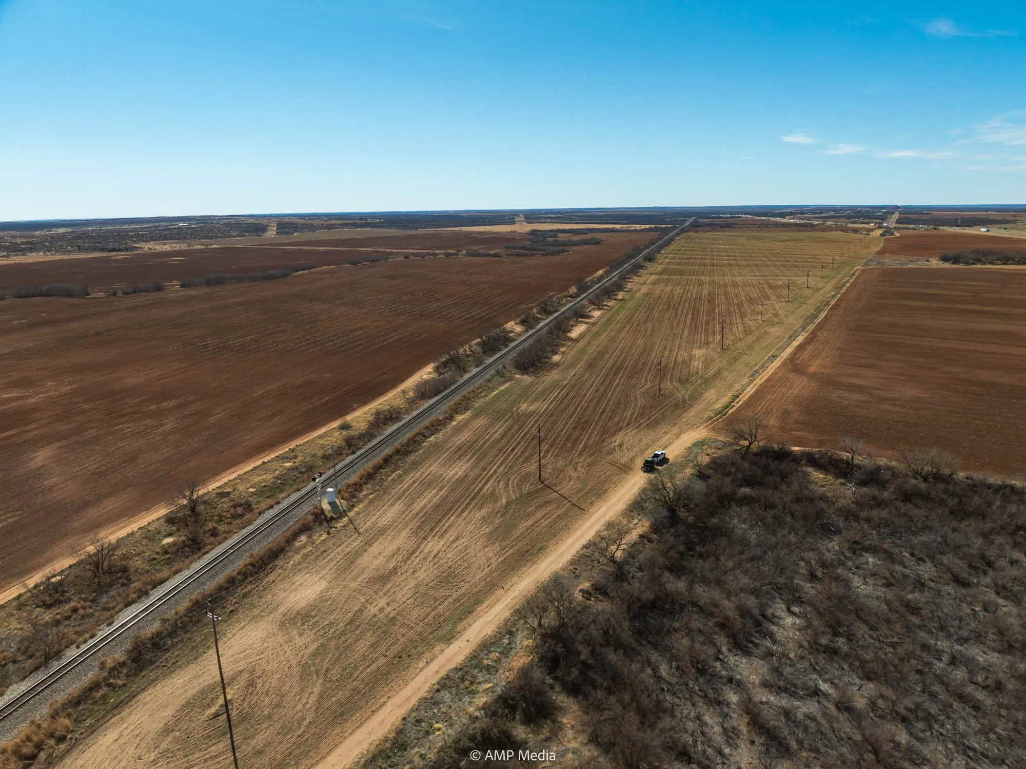 Aerial view of property's location with rural landscape and rows of crops