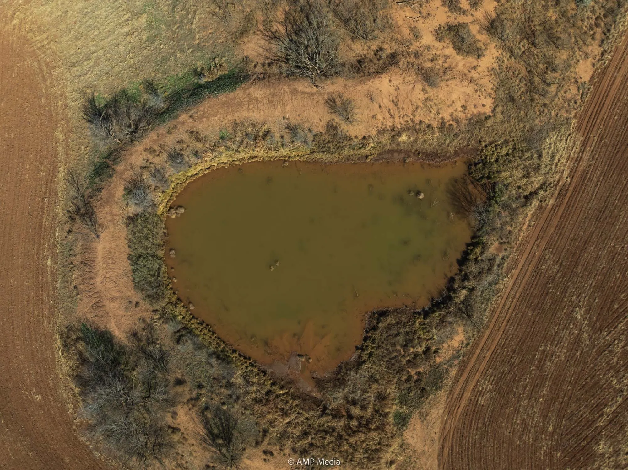 Aerial view of property's location with a large body of water and rural landscape