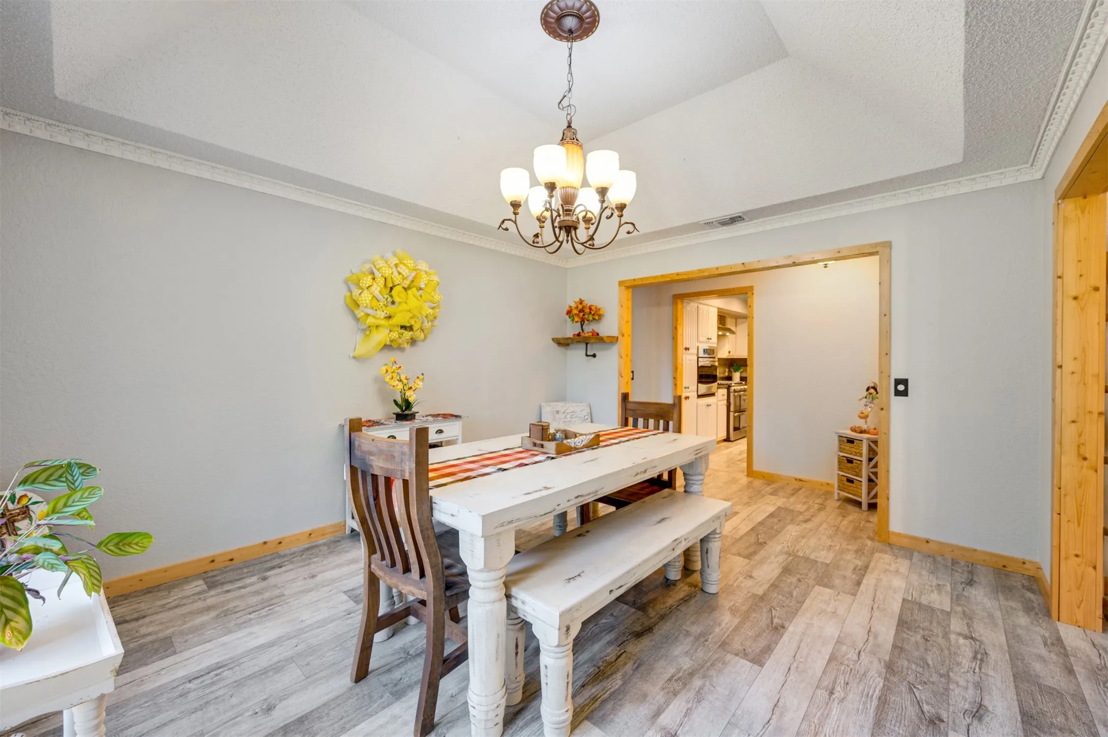 Dining space featuring a tray ceiling and crown molding