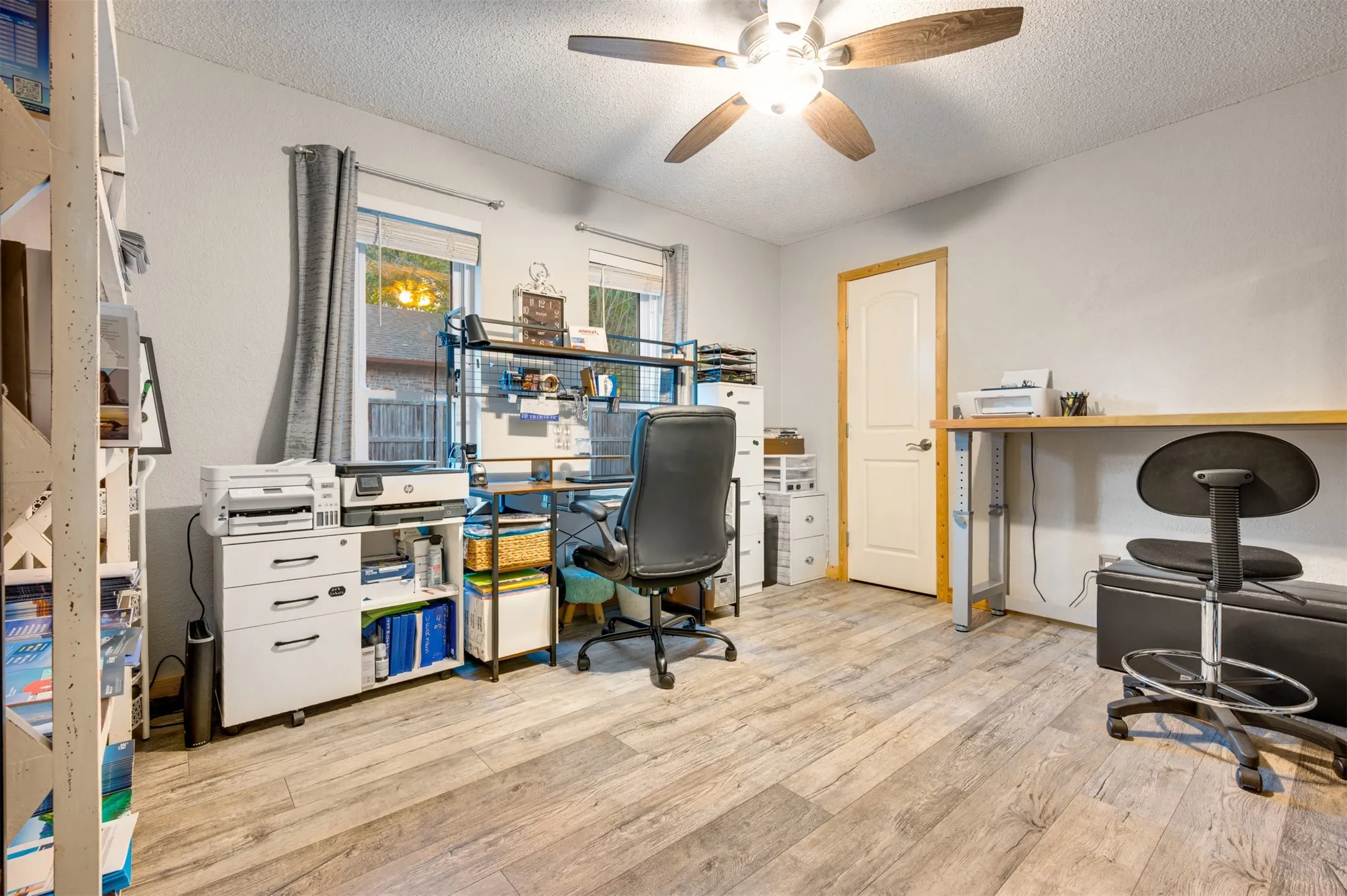 Hallway leads to second bedroom/office on first floor with walk in closet and hall bath