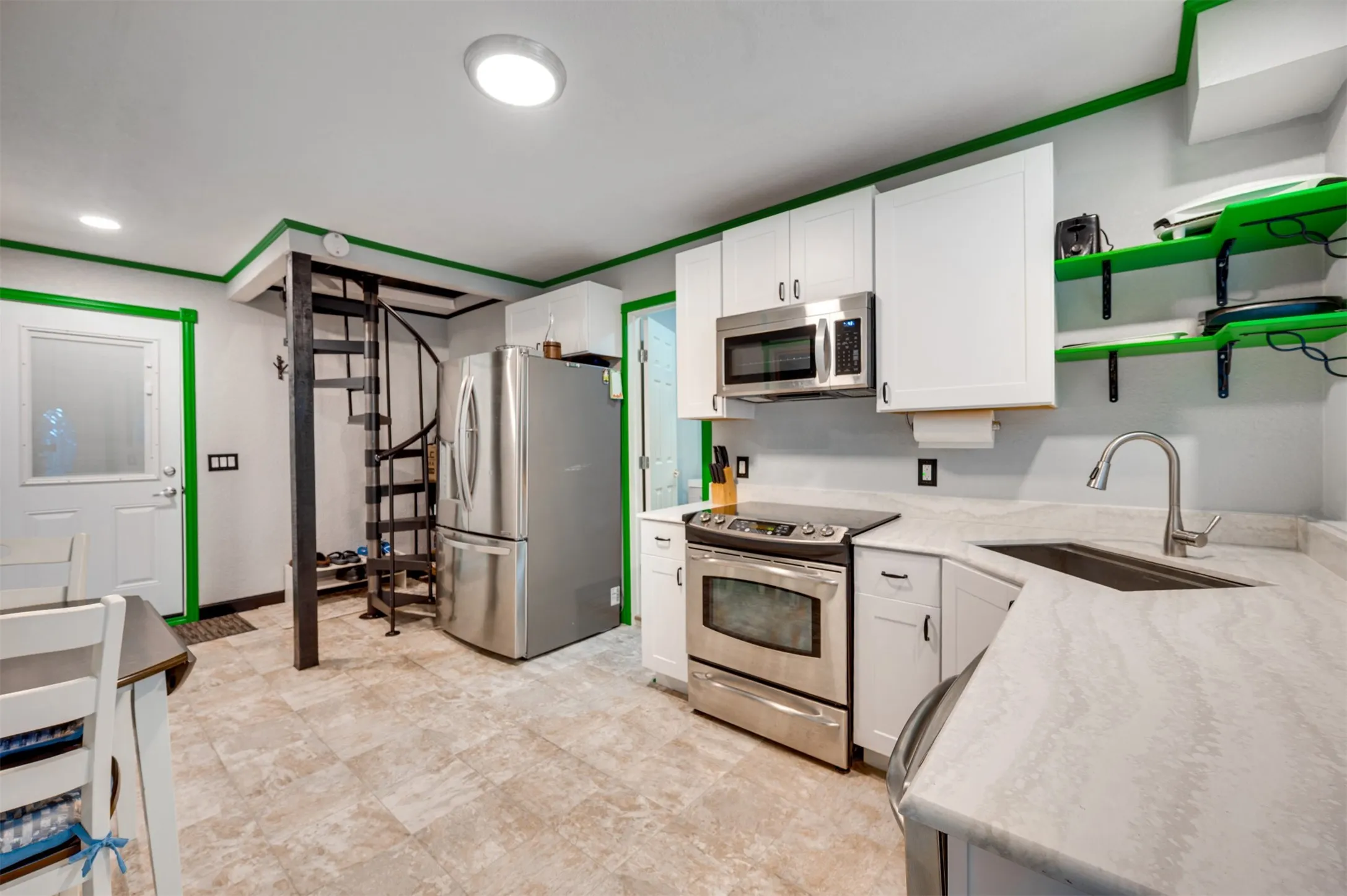 Down hallway from auxiliary bedroom and bath is a full kitchen