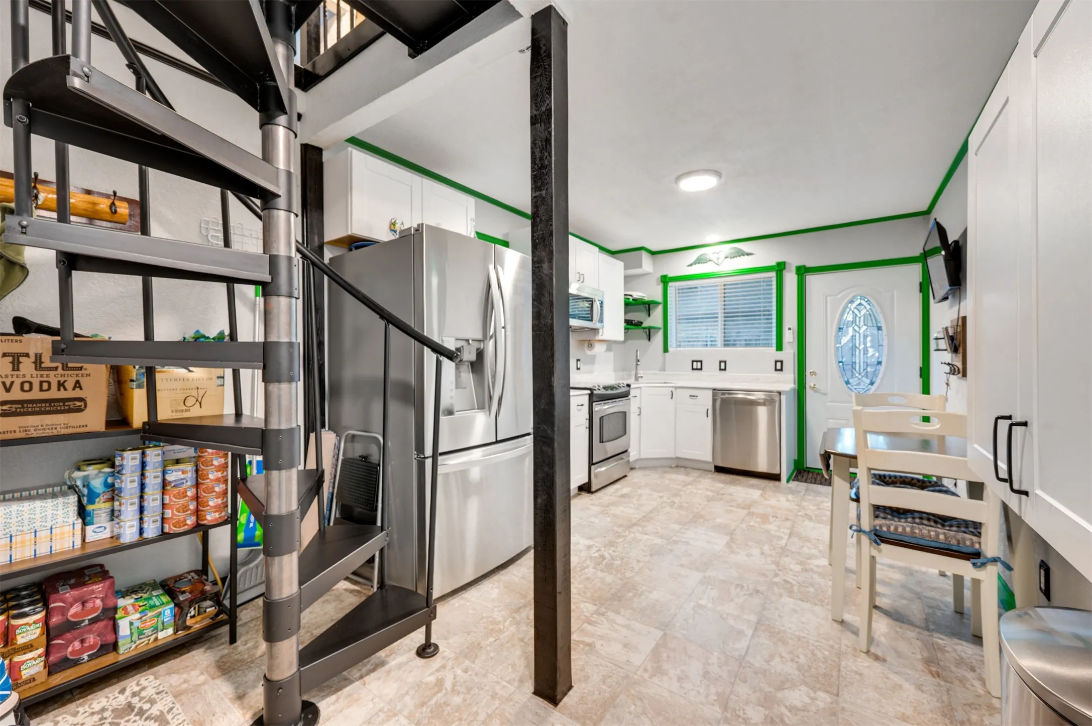 Separate entry and spiral stairs that lead to laundry room and bonus room upstairs
