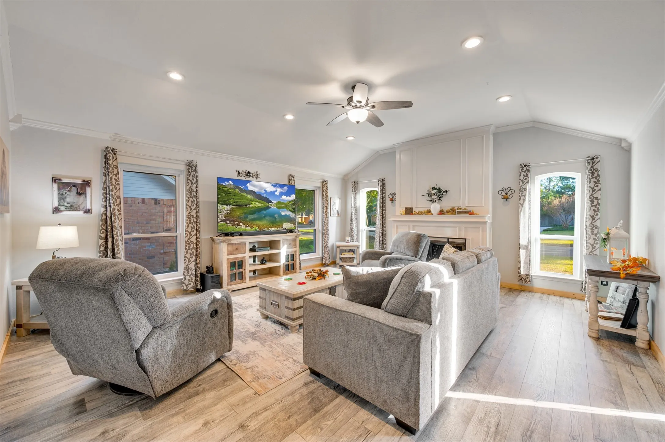 Living room with wood burning fireplace and vaulted ceilings