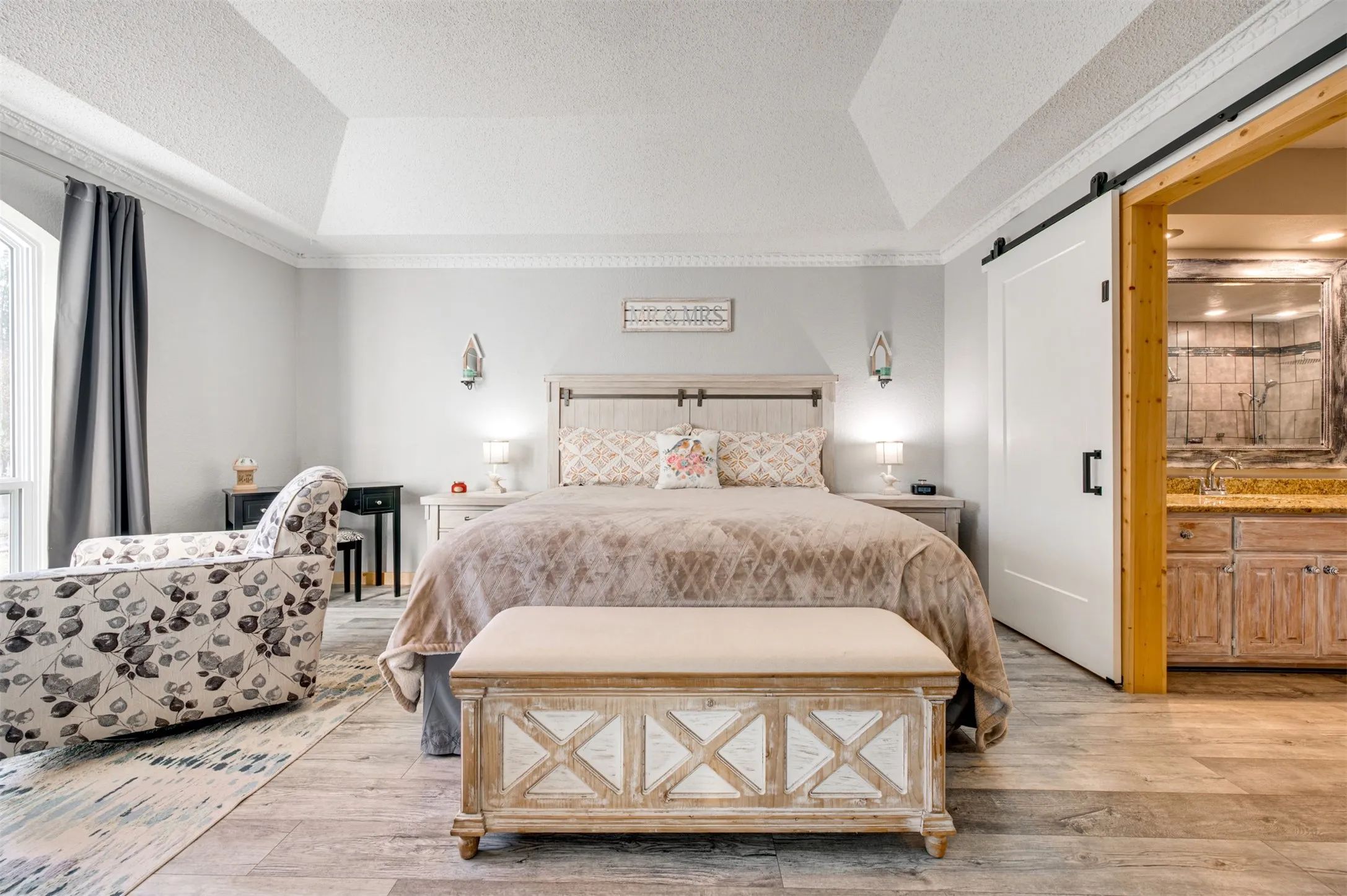 Barn door leads to remodeled en suite bath