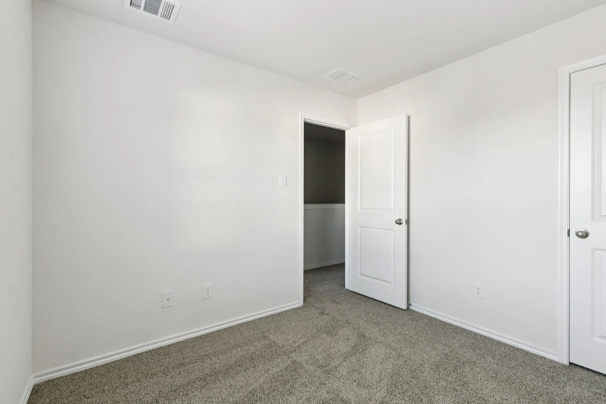 Unfurnished bedroom with carpet flooring and baseboards