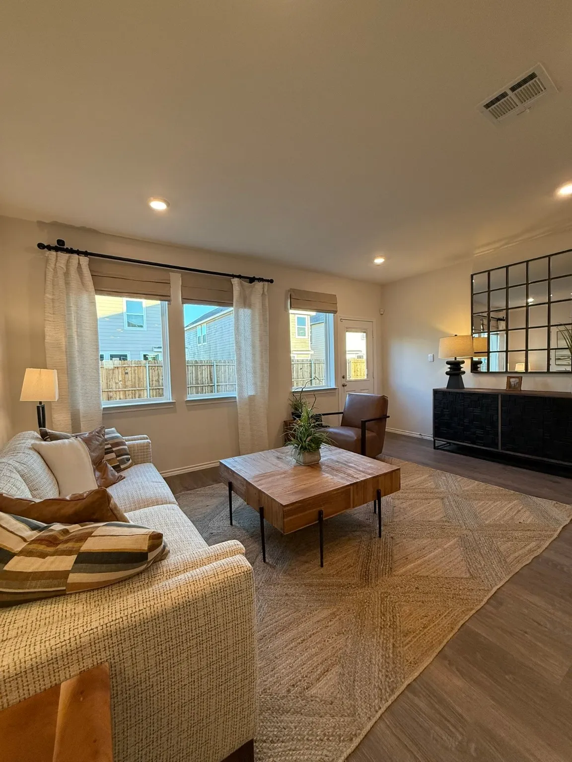 Living room with wood finished floors and recessed lighting