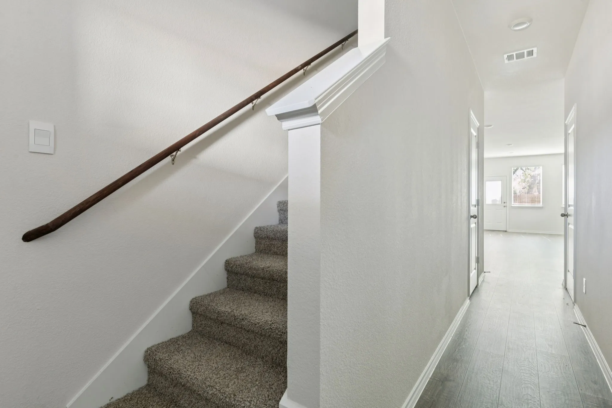 Stairs with baseboards and wood finished floors
