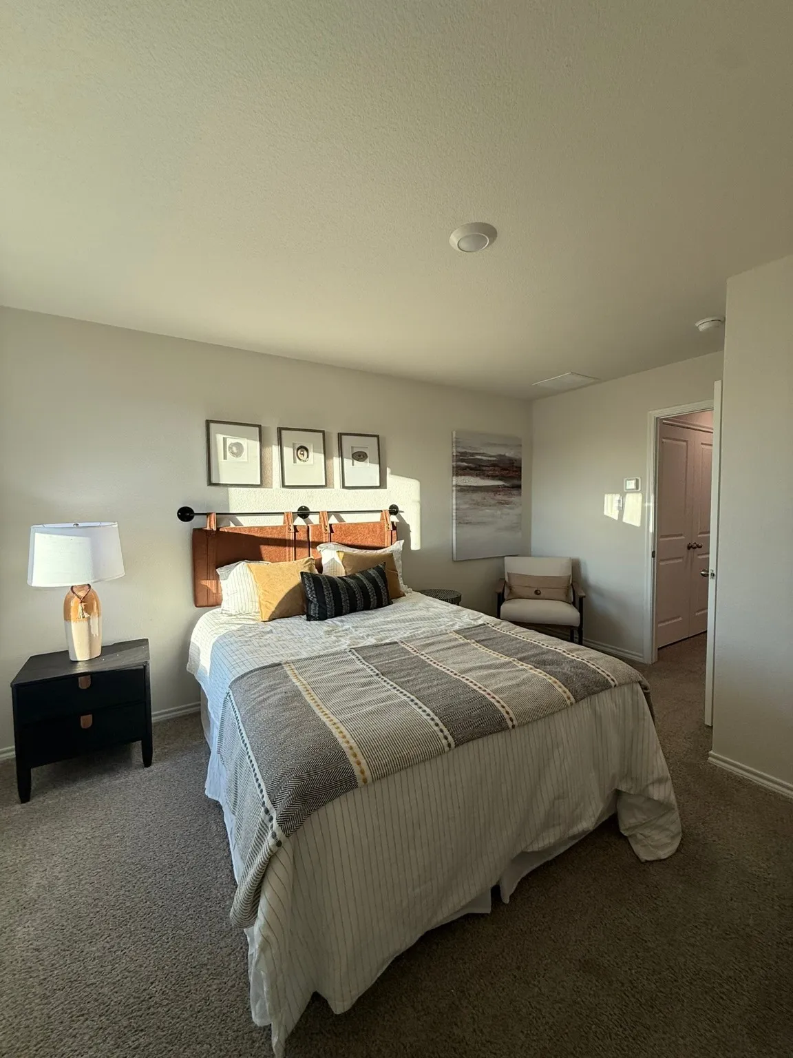 Bedroom featuring dark carpet and baseboards