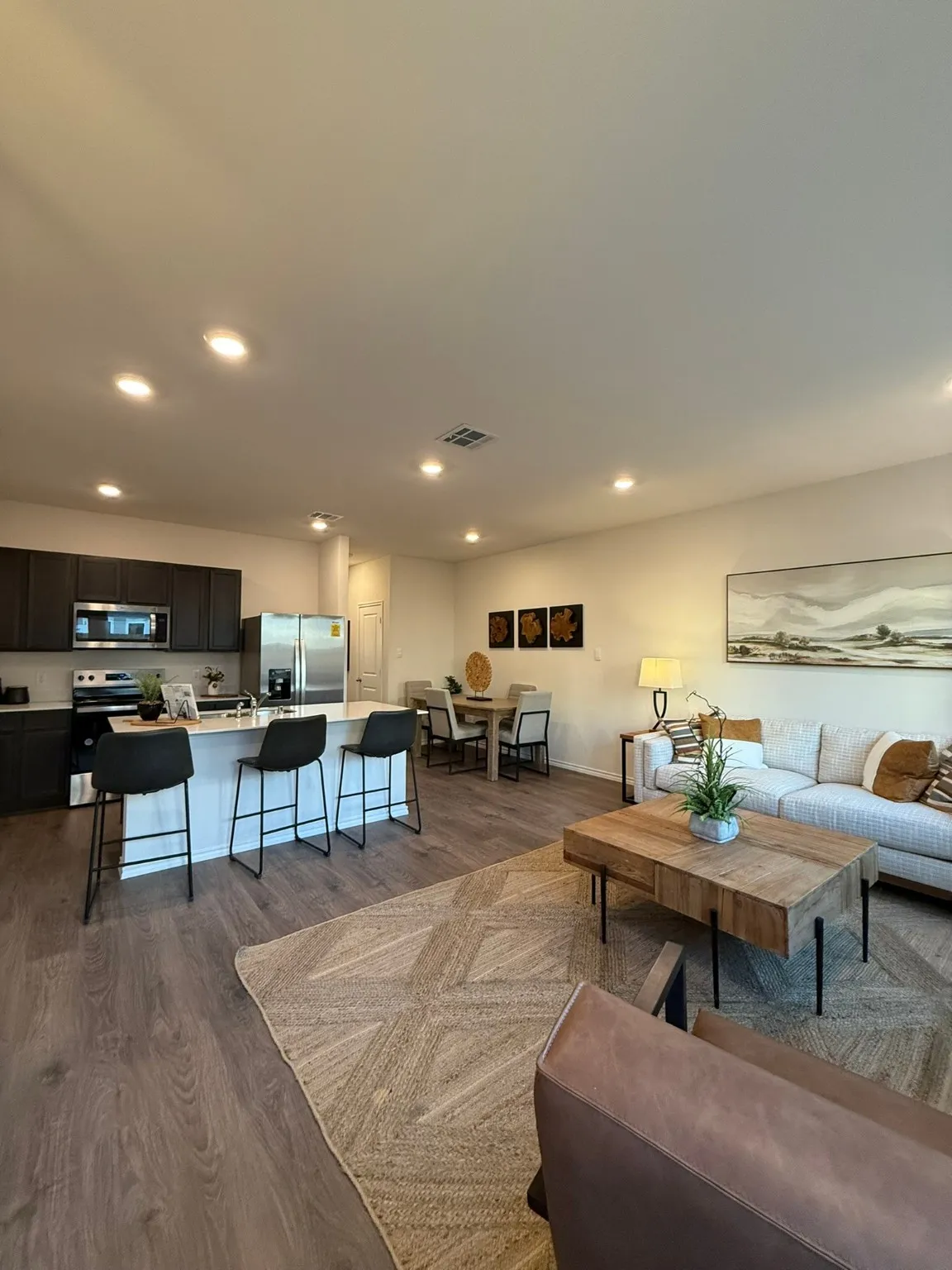 Living room with dark wood finished floors and recessed lighting