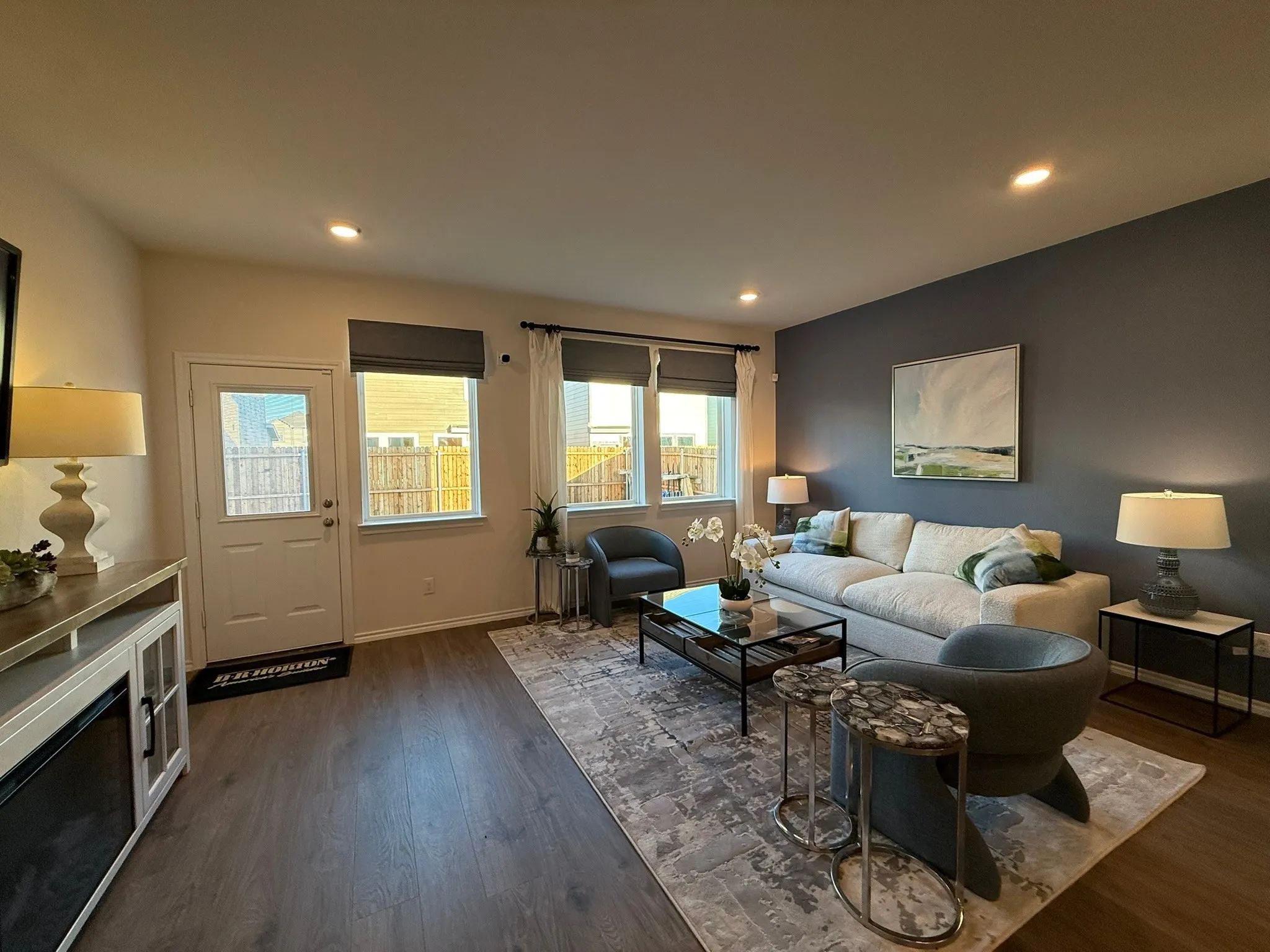 Living area with dark wood-style flooring and recessed lighting