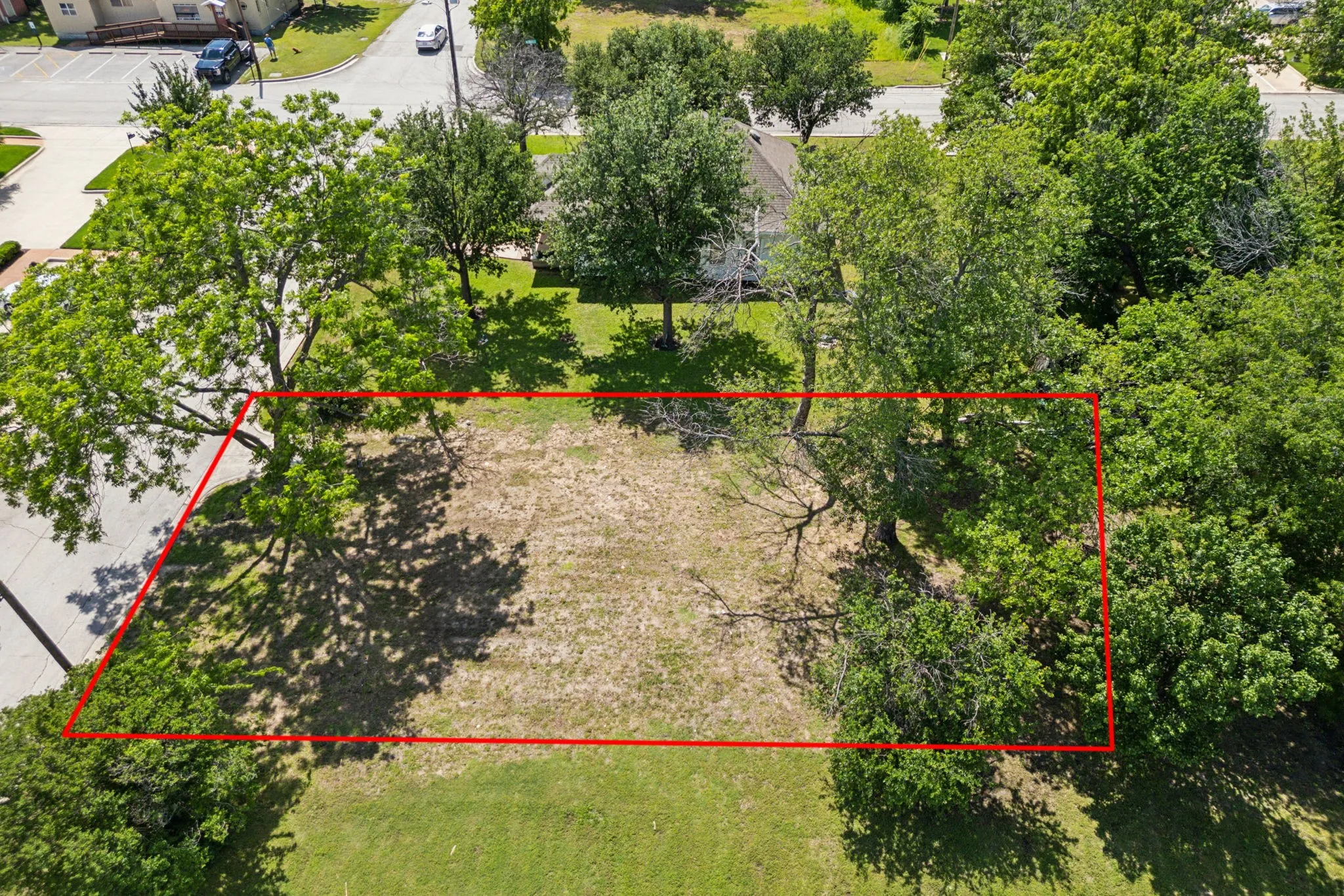 Aerial view of property and surrounding area featuring property parcel outlined