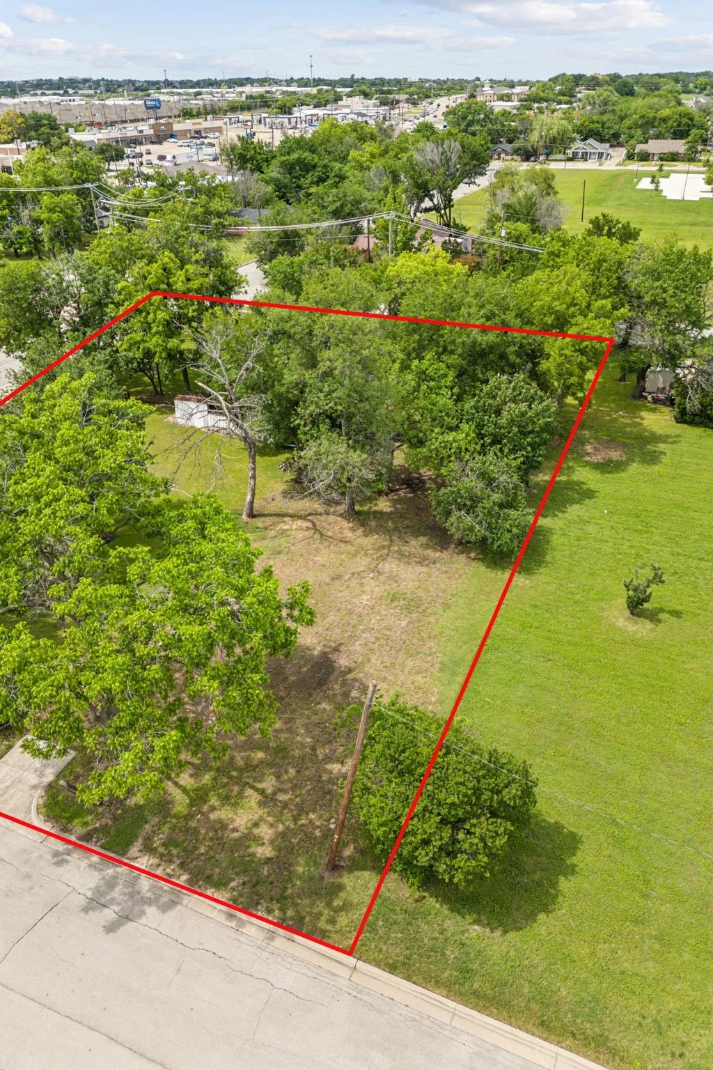 Aerial view of property and surrounding area with property parcel outlined