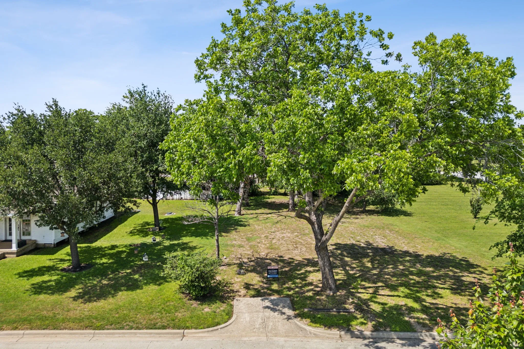 View of property's community with a lawn